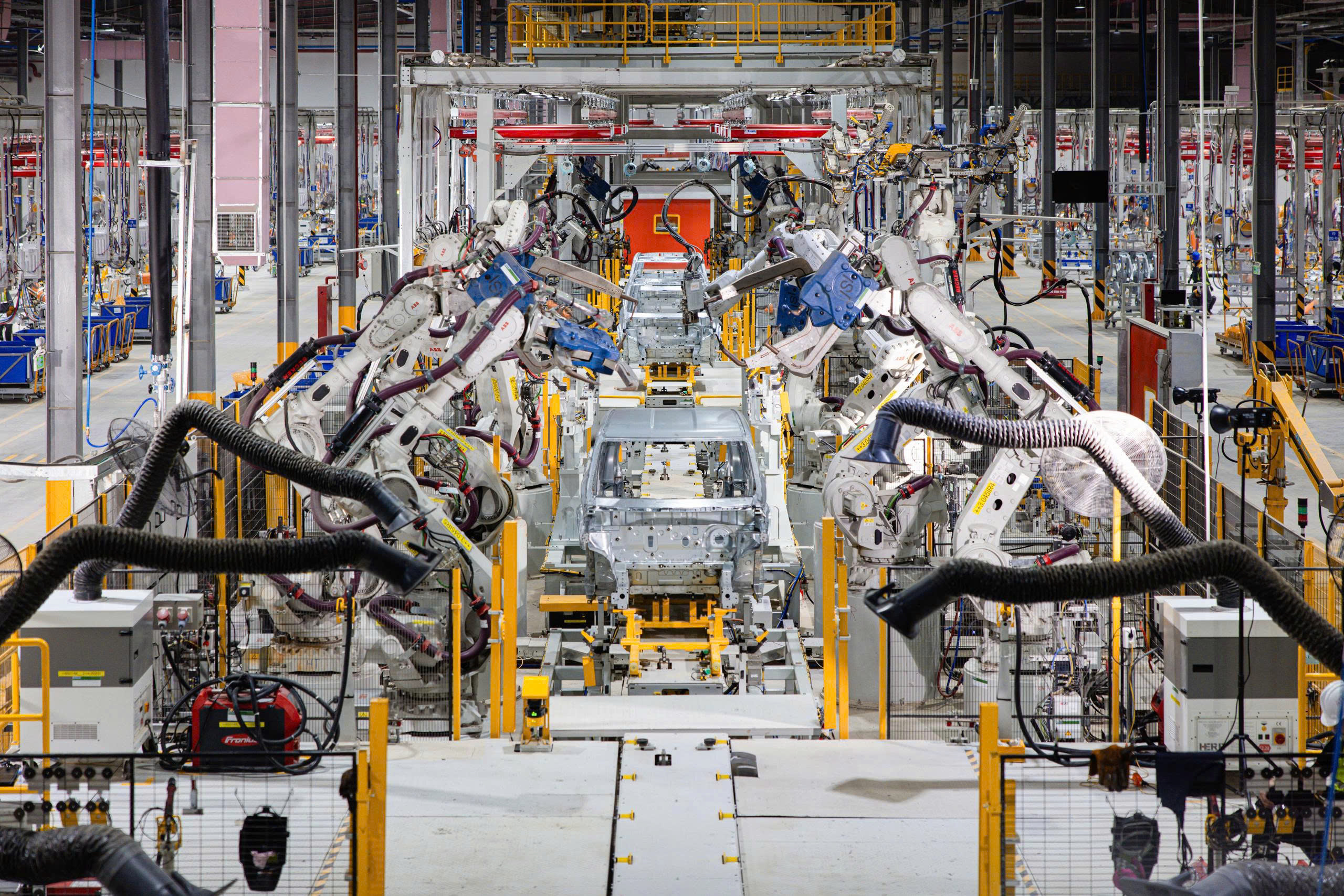 A factory with robots working on a carAI-generated content may be incorrect.