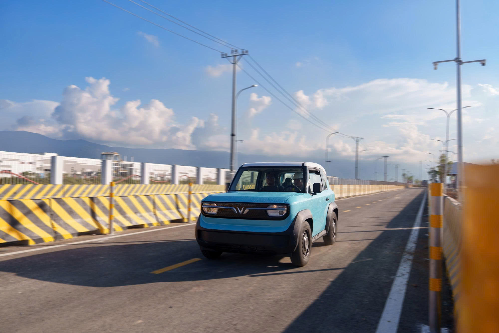 A blue car driving on a roadAI-generated content may be incorrect.