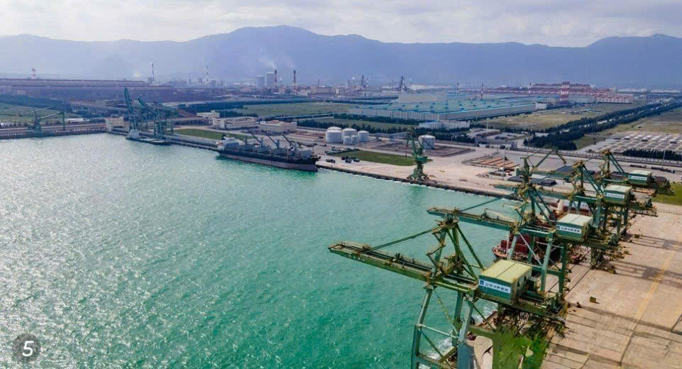 A large body of water with cranes and buildingsAI-generated content may be incorrect.