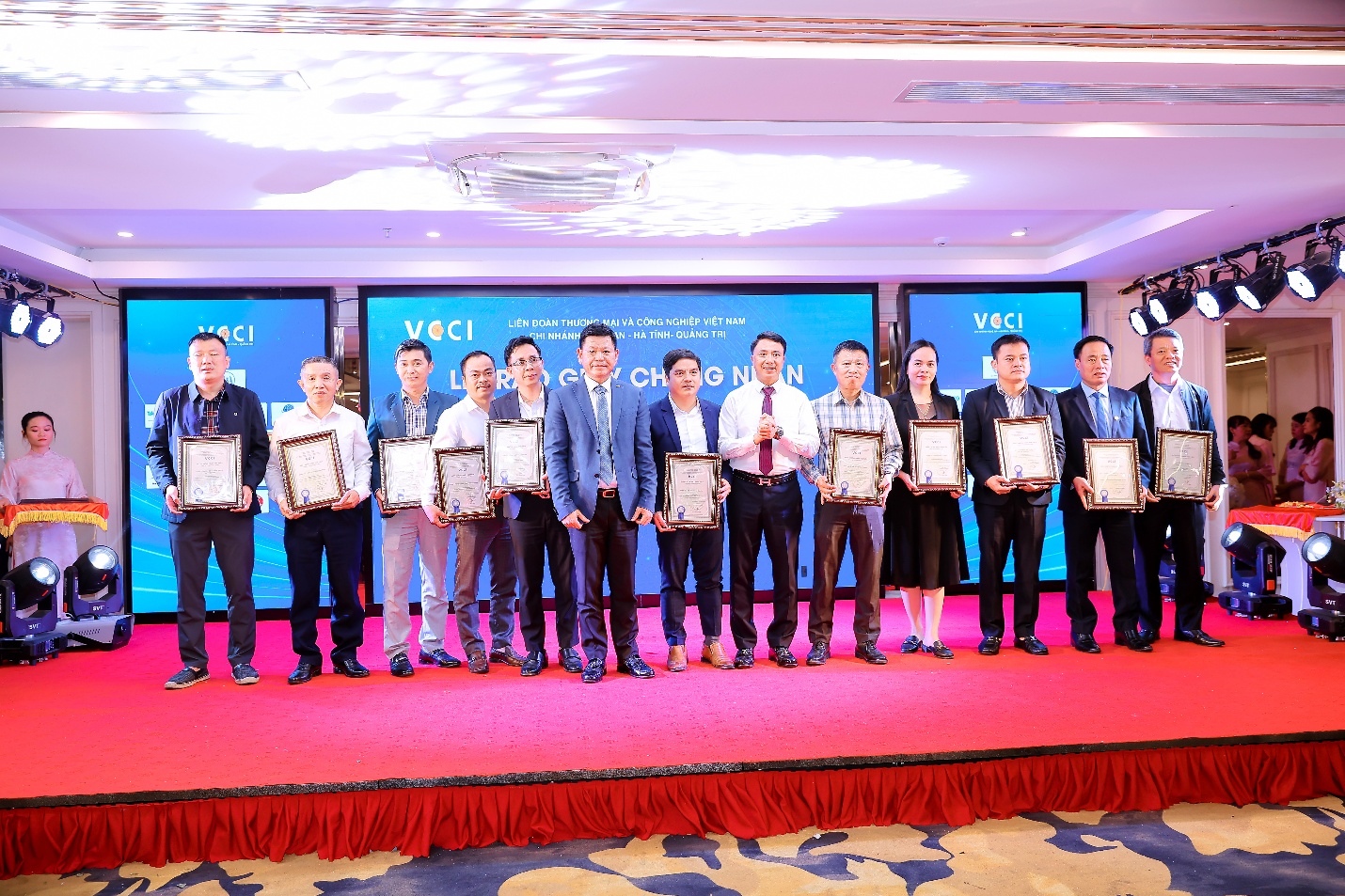 A group of people holding certificatesDescription automatically generated